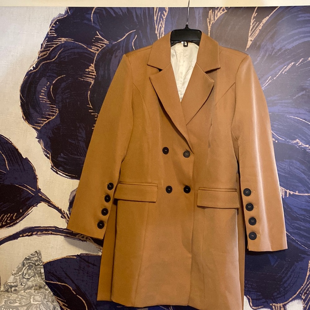 Like new.  Beautiful lined jacket in a a true camel color. Measurements in photo